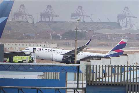 Two firefighters died after a plane collided with their truck and burst into flames at a South American airport
