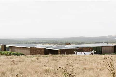 Gabion Walls Made of Volcanic Rock Flank a Flat-Roofed Farmhouse in Australia
