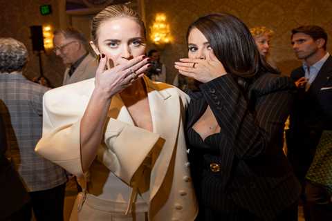 Selena Gomez and Emily Blunt cover their mouths as they pose together at the AFI Awards after viral lip-reading rumors