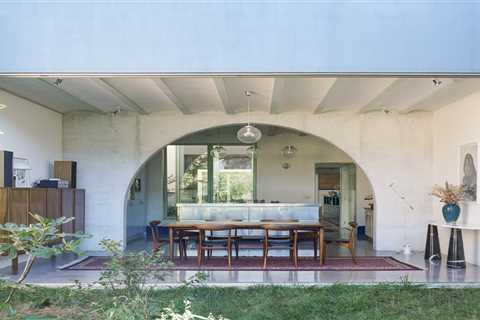 Grooved Red Tile, Arches, and a Catwalk Tie Together a Backyard House in Belgium