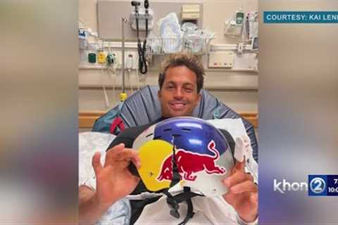 World champion surfer Kai Lenny holding his cracked helmet 'It may have saved my life'
