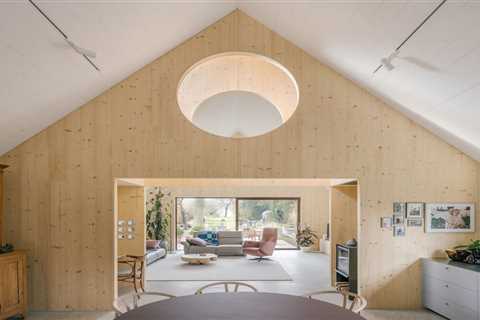 Timber Structures Pull Triple Duty Inside This Belgian Home for a Retired Couple