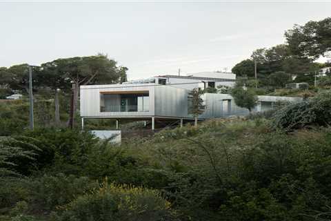 Wood Prefab Panels Cloaked in Galvanized Steel Form a Hillside Home in Barcelona