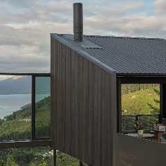 This New Zealand Tiny Cabin’s Glass Sliders Are So Big They Hang Off the Side