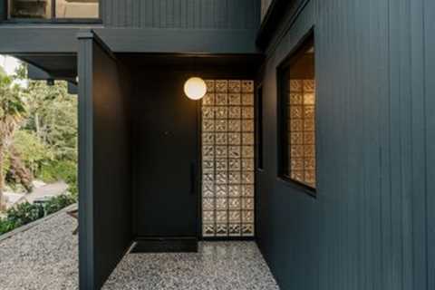 This $2.8M L.A. Midcentury Has an Ink-Black Facade and Bright-White Interiors