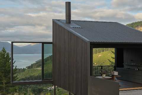 This New Zealand Tiny Cabin’s Glass Sliders Are So Big They Hang Off the Side